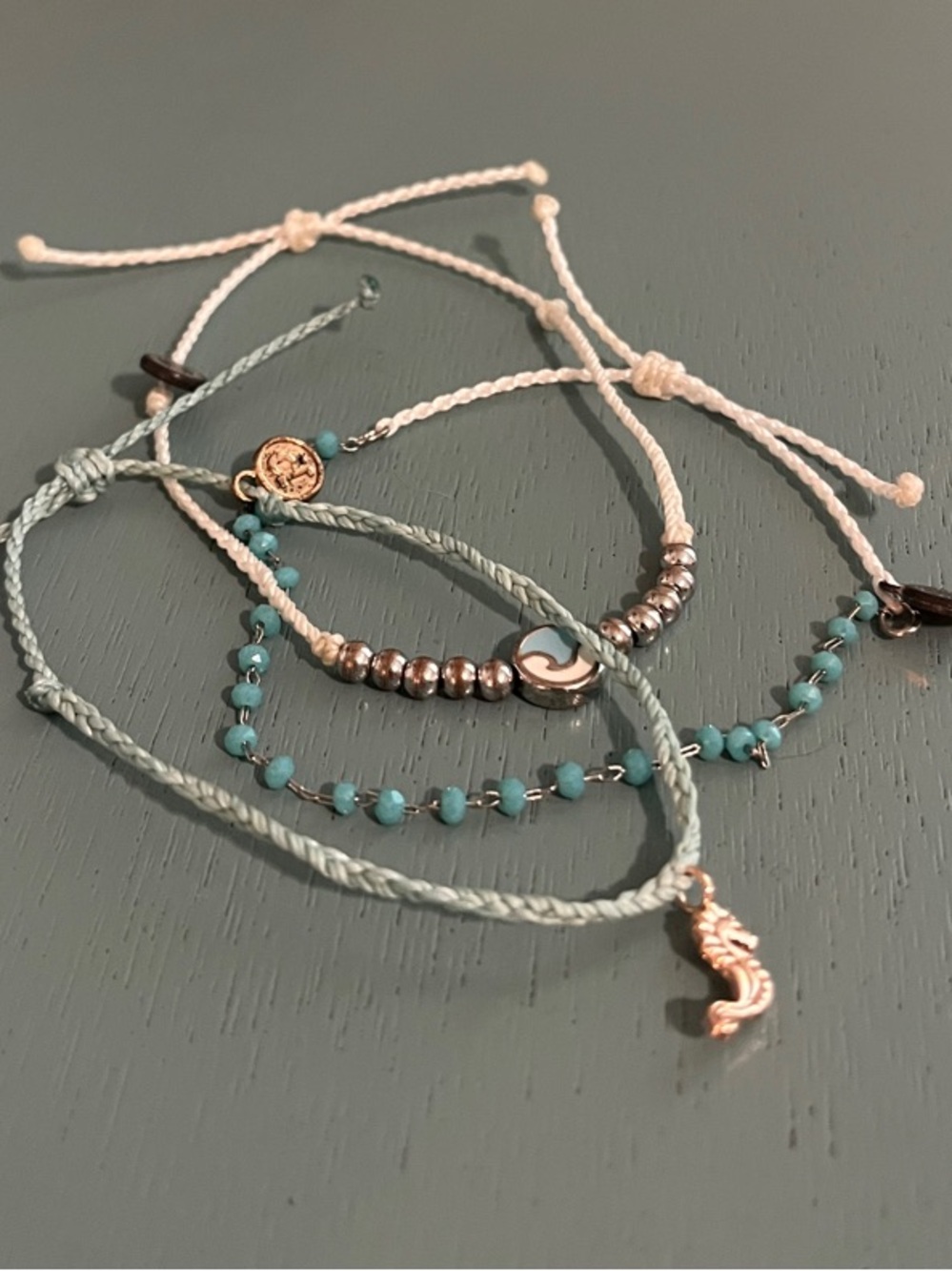 Three Pura Vida bracelets